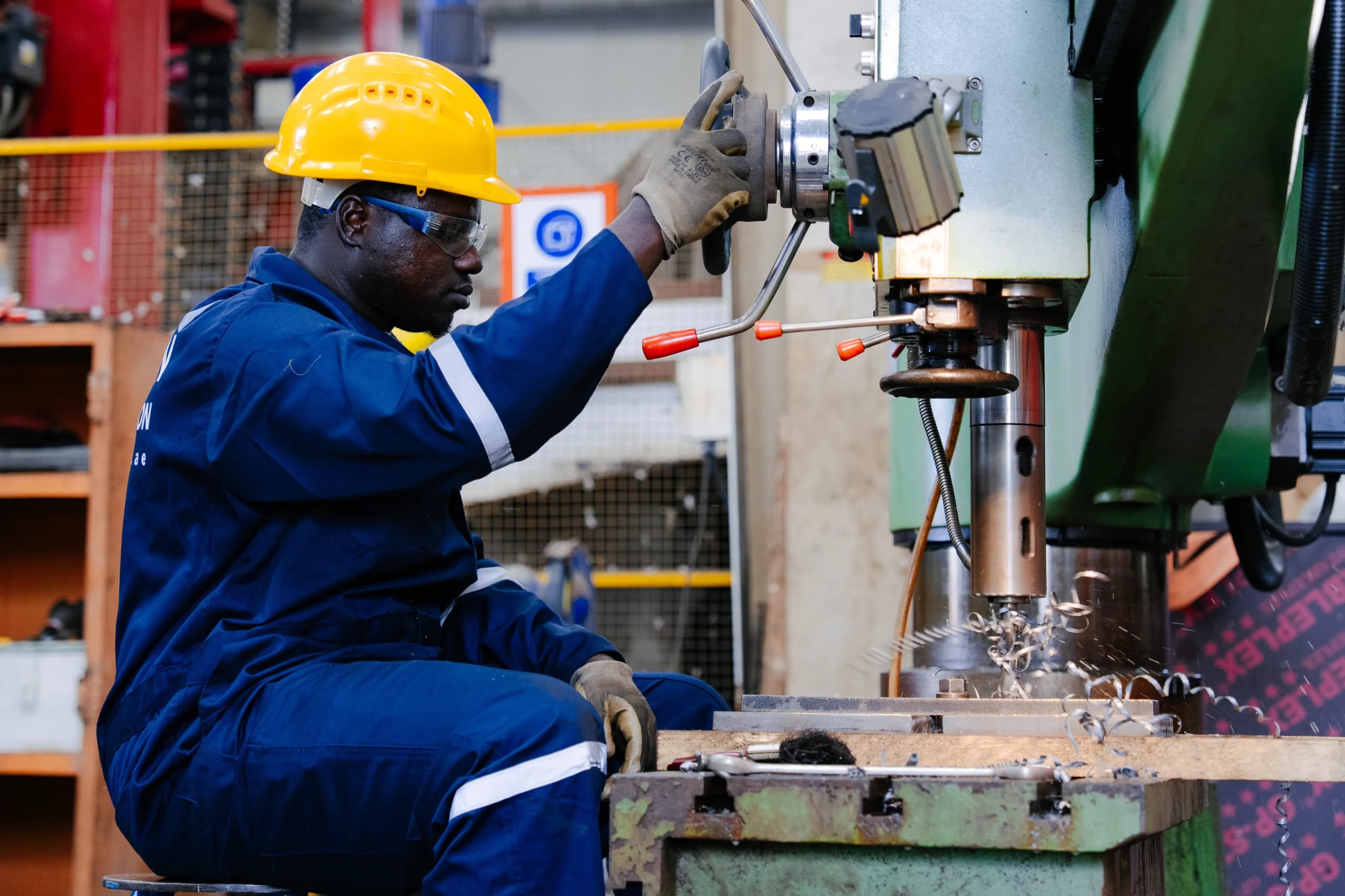 Dolphin Group technician in protective gear operating machinery in the workshop
