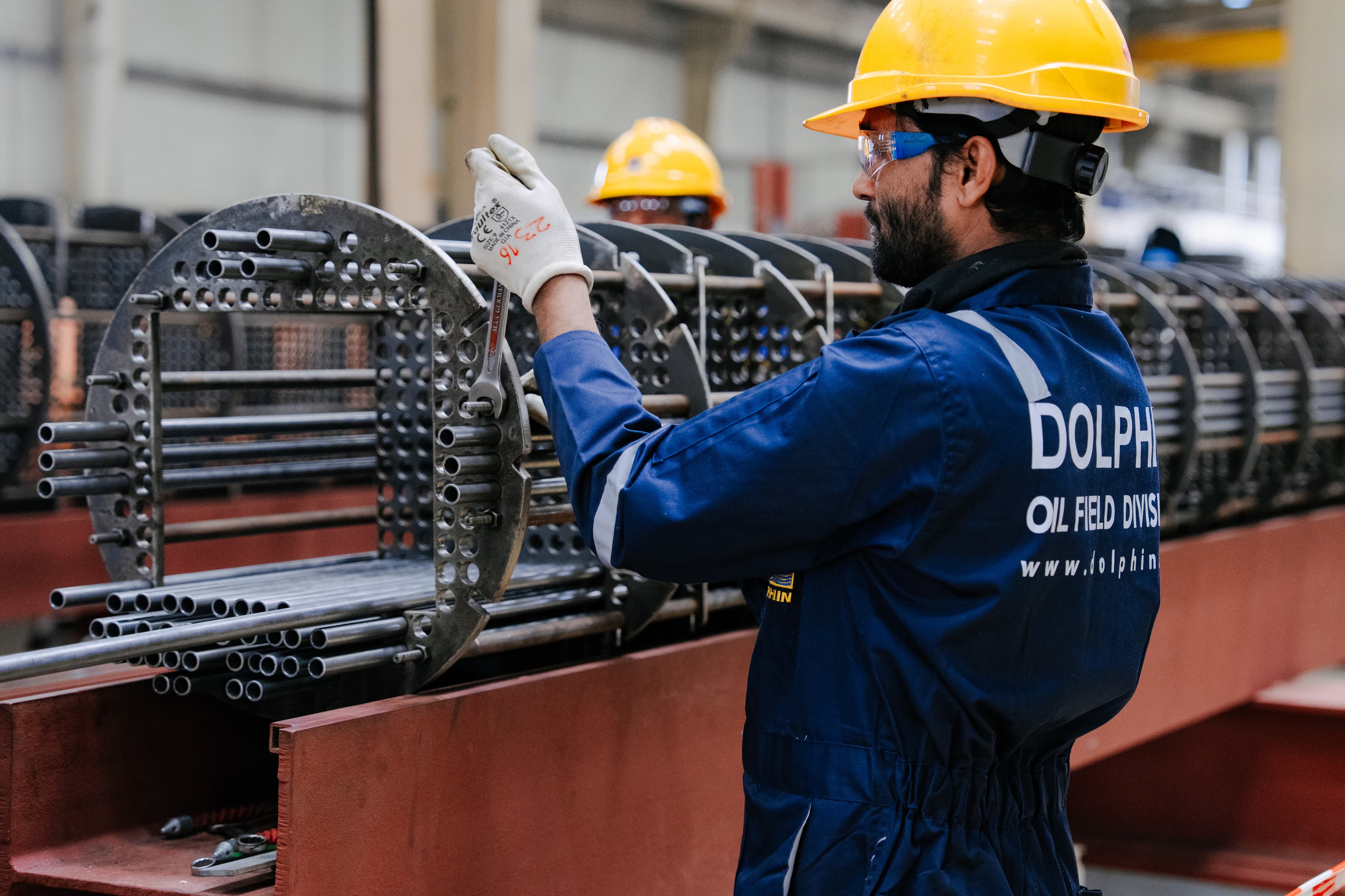 A Dolphin technician inspecting a shell and tube bundle on the shop floor