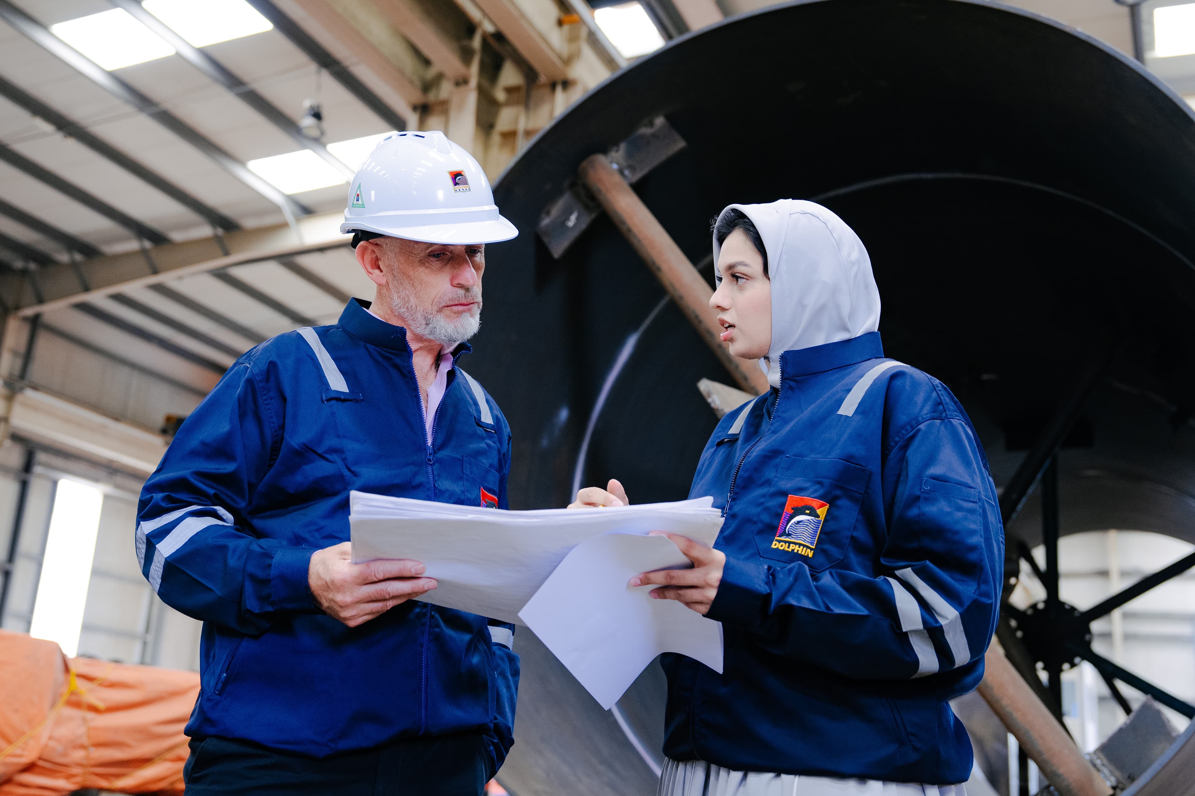 Two Dolphin colleagues reviewing engineering drawings together